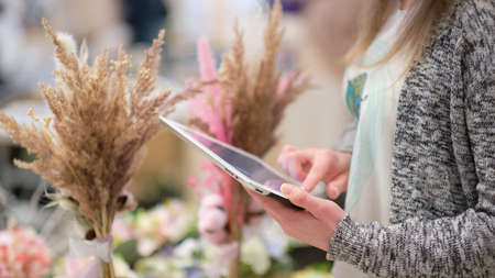 female uses a tablet to advertise their products and communicate with customers. online retail. concept of promoting an entrepreneur on the internet.の写真素材