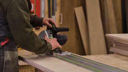 Woodwork and furniture making. Joinery, woodworking and furniture making, professional carpenter cutting wood in carpentry shop, industrial conceptの写真素材
