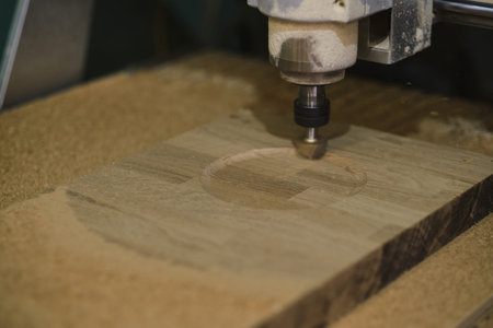 Milling a wooden board. Processing of wood panels on CNC coordinate milling woodworking machines....