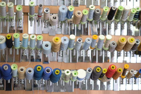 group of sewing threads in skeins. A bunch of large multicolored spools of thread. Atelier workshop....