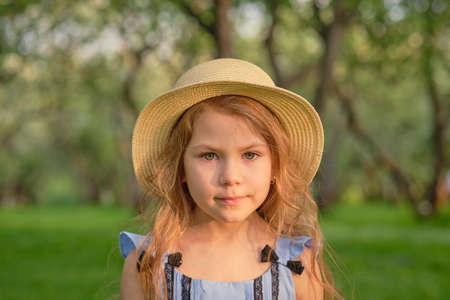 portrait of a young serious girl in a straw hatの写真素材