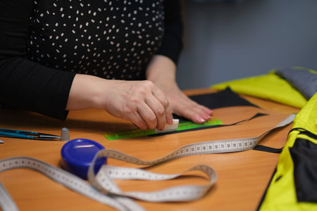 unrecognizable professional seamstress, hand tailoring, sews fabric by hand.の写真素材