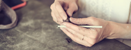 artisan pottery tutor. womens hands shake a piece of gray clay. Pottery made of clay with their own hands. Holding a grey ballの写真素材