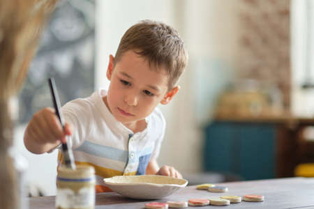 workshop for kids. Children learning how to use clay for making beautiful dishes. Workshop, master class.の写真素材