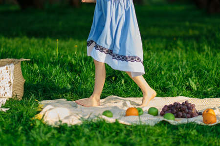 barefoot girl walks on the grass in the park. knives of a girl walking towardsの写真素材