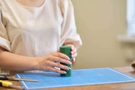 Hand made yellow candles from natural bee wax. The process of creating candles with your own hands. Master class on creating candles at table, closeupの写真素材