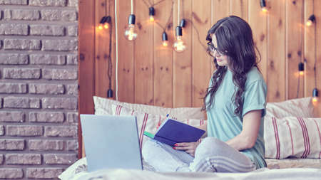 middle-aged woman is undergoing online training to get a new profession. the concept of professional retrainingの写真素材