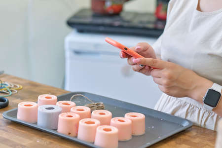 Hand made yellow candles from natural bee wax. The process of creating candles with your own hands. Master class on creating candles at table, closeupの写真素材