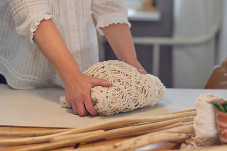 woman entrepreneur packs a handmade product in a cardboard box. delivery of goods for a small...