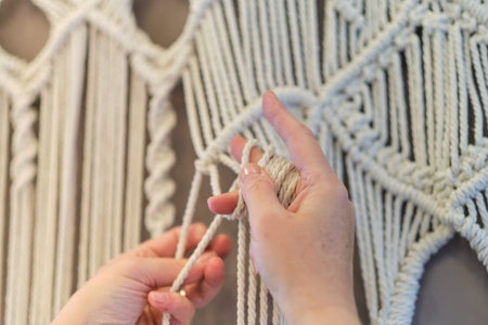 Close-up of hand made macrame texture pattern. ECO friendly modern knitting natural decoration...