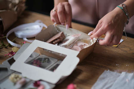 small business owner, online marketing packaging box and delivery. A parcel wrapped in brown paper. Delivery concept for private companies delivery with care. Craft present boxの写真素材