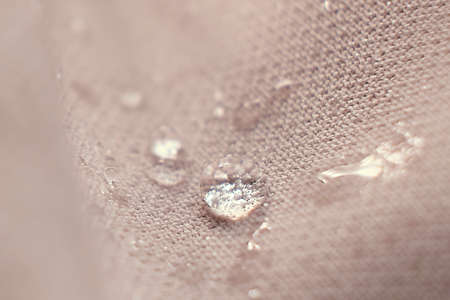 water beading on fabric. Waterproof coating background with water drops. soft focus, blurの写真素材