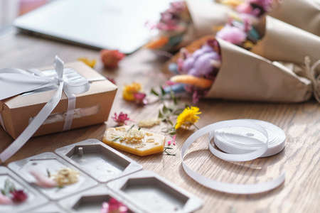 dried flowers, aromatic sachets made by hand. Autumn composition on a wooden table. Gift Box with, postcard layout with copy space for text.の写真素材