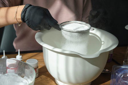 handmade bath bombs process. Preparation of bath bombs. Ingredients and floral decor on a wooden...
