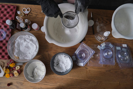 handmade bath bombs process. Preparation of bath bombs. Ingredients and floral decor on a wooden...