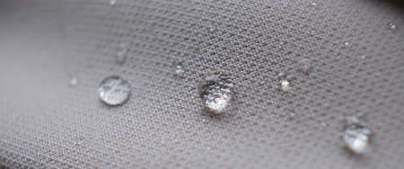 water beading on fabric. Waterproof coating background with water drops. soft focus, blurの写真素材