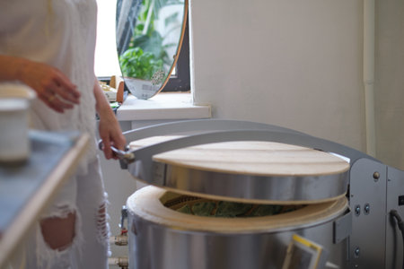 female potter put it into a kiln for firing. Kiln in Potters workshop with pottery. Electric oven...