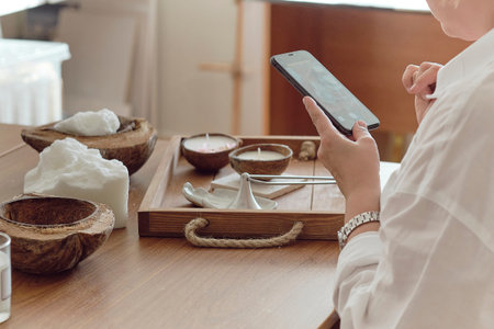woman entrepreneur makes stylish photos on a smartphone to advertise herself on social networks....