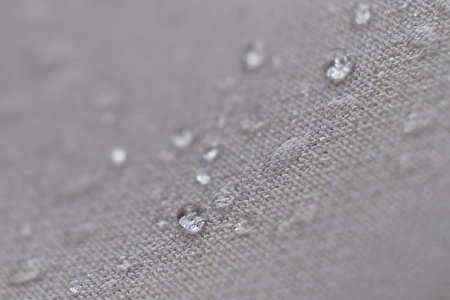 Water Proof Textile block water to pass through to stay dry. water beading on fabric. soft focus,...