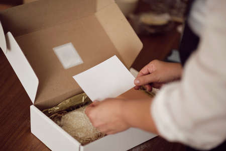 small business owner, online marketing packaging box and delivery. A parcel wrapped in brown paper. Delivery concept for private companies delivery with care. Craft present boxの写真素材