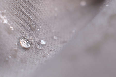 water beading on fabric. Waterproof coating background with water drops. soft focus, blurの写真素材