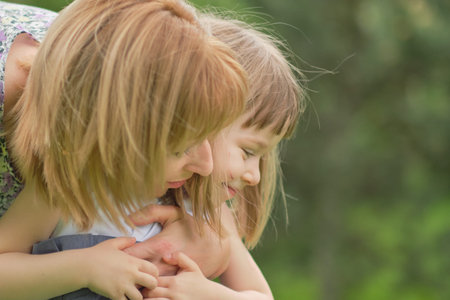 Side view close up head shot happy mom hugs her little daughter, photo in motion, soft focus, love...