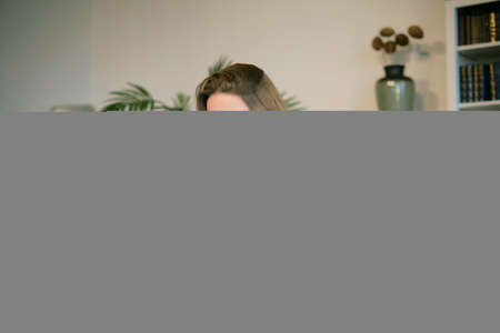 Teenage girl doing homework at a desk in her bedroom. teen girl school student write notes watch video online webinar learn on laptop. distance elearning course video conference pc call.の写真素材