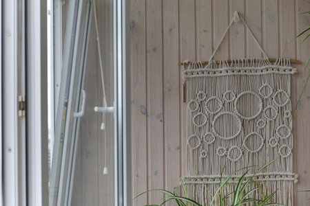Beautiful boho macrame on wall panel. tapestry in the style of Boho made of cotton threads in...