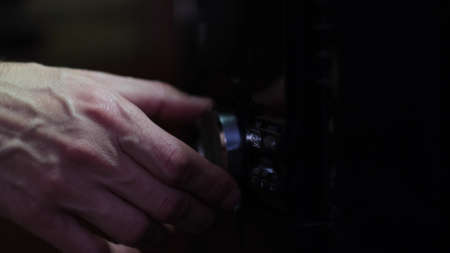 Mans hand adjiusting volume knob of subwoofer audio amplifier,volume control music concept. Raise the sound on musical equipment.の写真素材