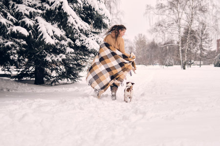 portrait of a woman in a snowy forest. woman enjoying winter moments in a snowy park. frozen winter...