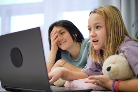 shocked teenagers look at the laptop. safe internet concept for kidsの写真素材