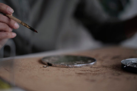 Stained glass maker works with colorful souvenirs. Female hands soldering the stained glass,...