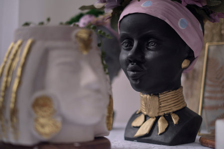 African American Woman bust. pots for flowers in the form of a womans head. soft focus