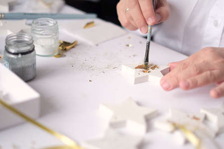 Applying Gold Leaf. woman Artist decorates the gold plaster craft. hobby and creativity concept.の写真素材