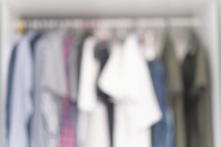 blur storage closet with hanging clothes of male fashionable style background. Wardrobe blurred...