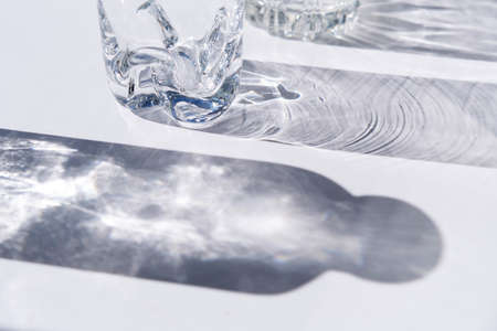 Minimal luxury background. Trendy pattern made with glasses and shadows. glass with sparkling sunlight shadow. unlight and blank businessの写真素材