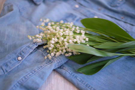 flowers, and clothes on a wooden background. Concept for organic, recycled clothes and eco-friendly, ecological fashion. Eco friendly fabric shop.の写真素材