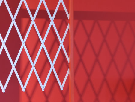 reflection of white bars on a red wall. geometric shadows on the wall.の写真素材