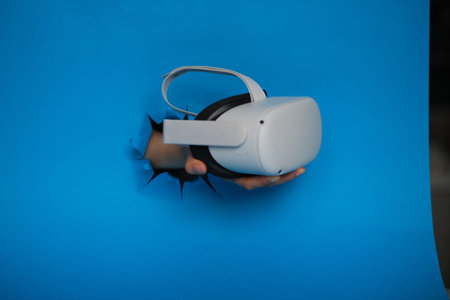 female hand holding Virtual reality glasses on a blue background
