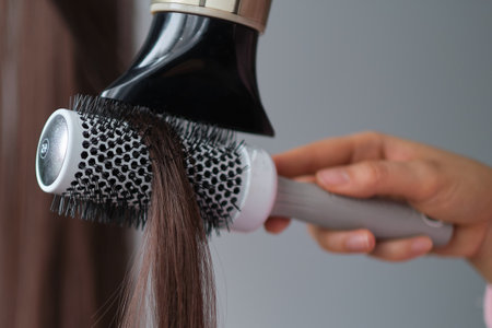 simple minimalist photo, blow dry hair styling. Close-up of hair dryer, concept cut salon, female stylist.の写真素材