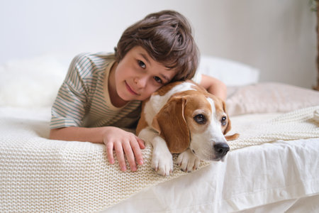 Animal-Assisted Therapy for Kids. charming smiling boy and his beagle. therapeutic approaches involving pets and the ways in which they can help children with social, emotional, or cognitive challenges.の写真素材