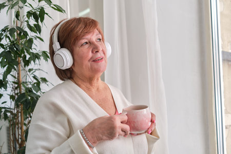 old lady standing by a window, lost in her thoughts while listening to music or a podcast, to evoke...