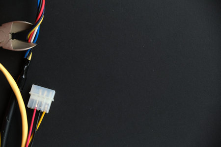 Electrician cuts electrical wires with pliers. Cutting pliers and cable. A cutter is cuting...