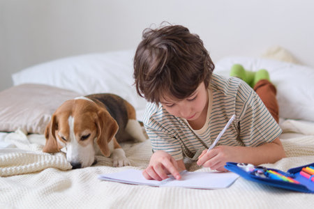 serene scene boy immersed in his drawing while his furry friend relaxes nearby, demonstrating how artistic expression and a calming environment can work together to promote mindfulness in children.の写真素材