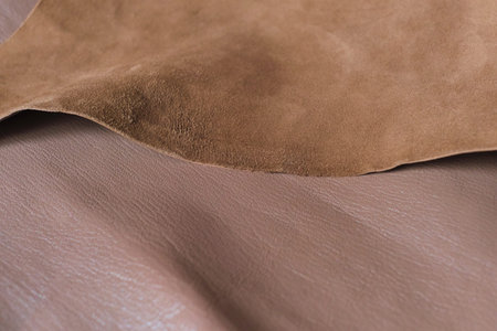 close-up shot of high-quality brown leather showcasing its intricate texture and rich color.