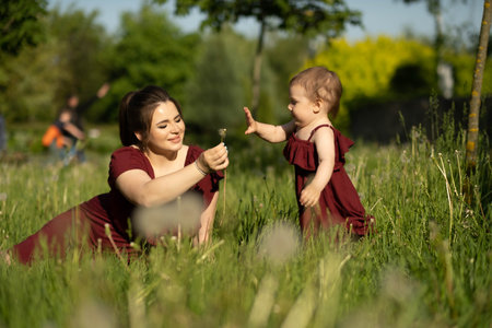 tranquil day in the park, a mother cherishes her time with her one-year-old daughter. Concept: Tranquility and Mindfulnessの写真素材
