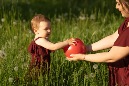 tranquil day in the park, a mother cherishes her time with her one-year-old daughter. Concept: Tranquility and Mindfulnessの写真素材