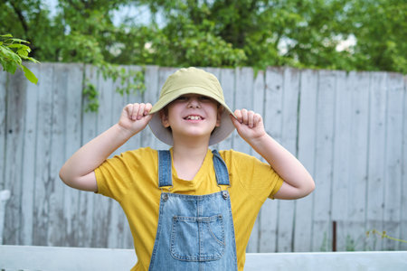 A delightful picture of a boy in a playful pose, his attire and joyful expression representing the thrill and pleasure of childhood games.の写真素材