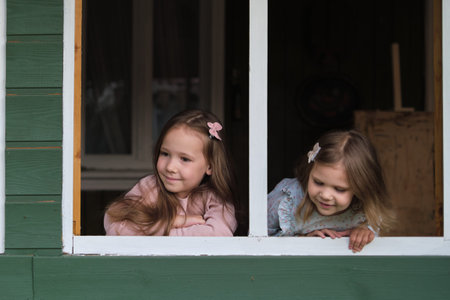 Close-up of the green wooden window frame, the girls hands pressing on it, suggesting the memories...