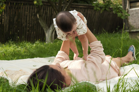 Simple Joys of Life: This photo, capturing a young mothers exuberant play with her baby on a simple...